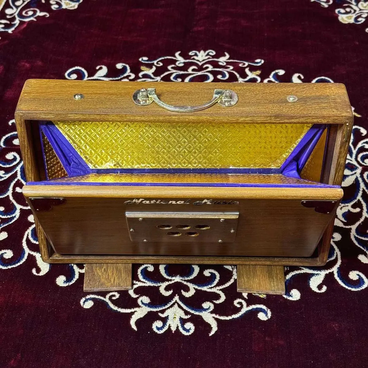 bellows opened of brown teak wood shruti box