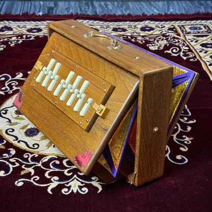 brown teak wood shruti box standing straight on its stand