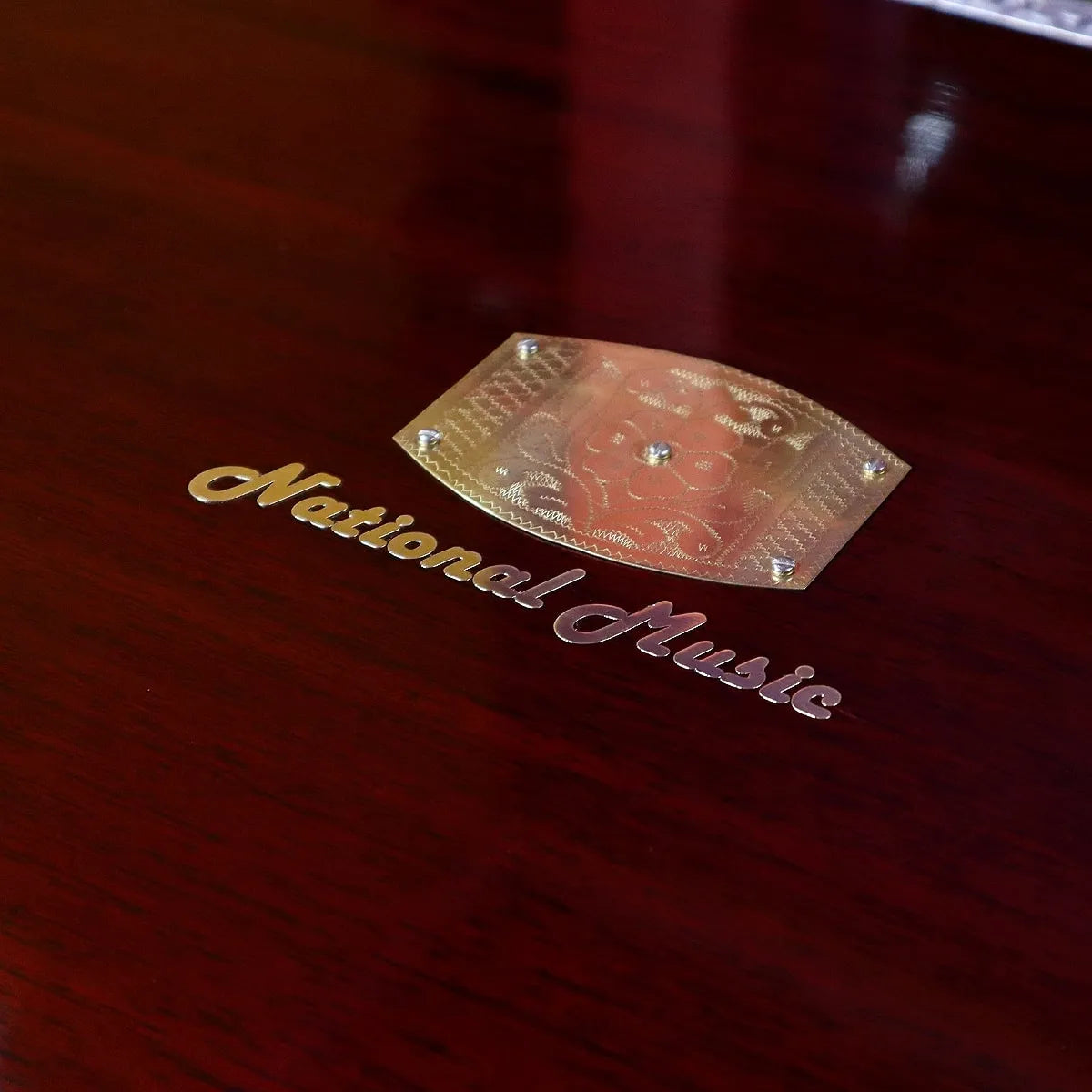 national music brand logo on the brown walnut harmonium case and a shiny engraved steel plate highlighting the craftsmanship